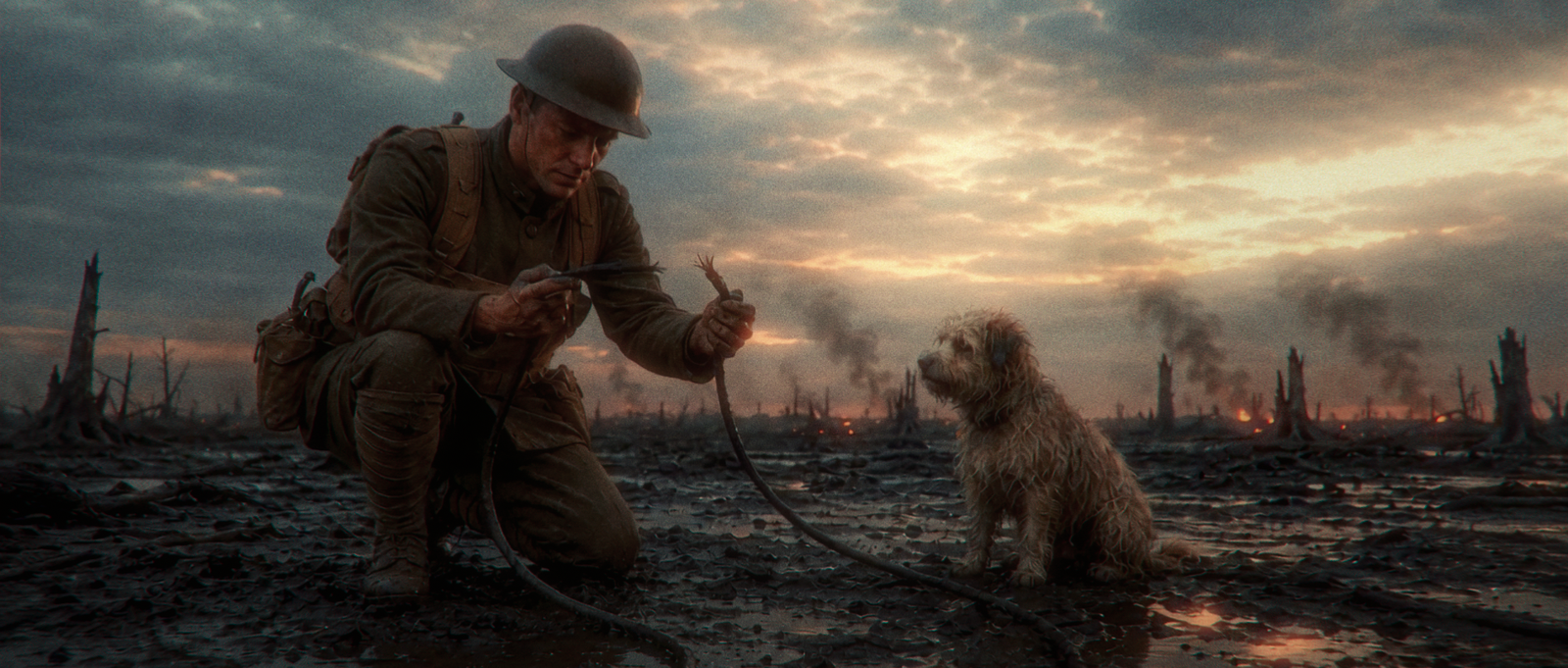 Donovan kneeling beside Rags while repairing a broken field communication wire.