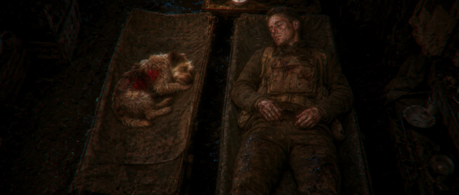 Rags and Donovan lying wounded on adjacent stretchers after battle.