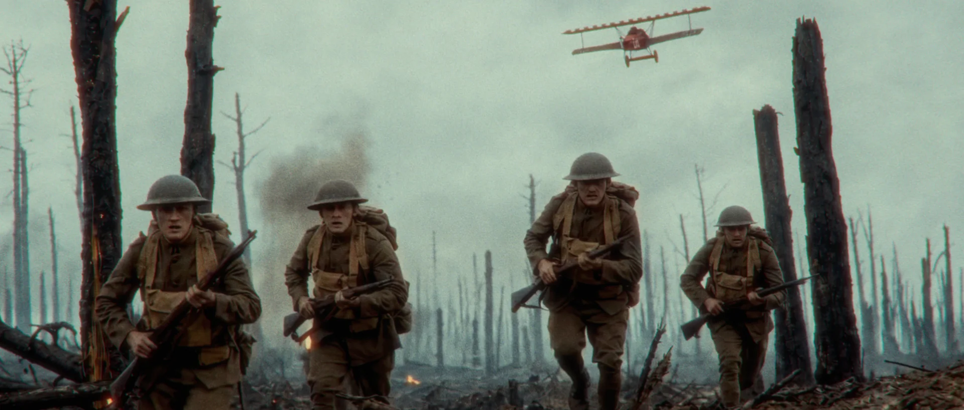 Soldiers advancing across a devastated battlefield